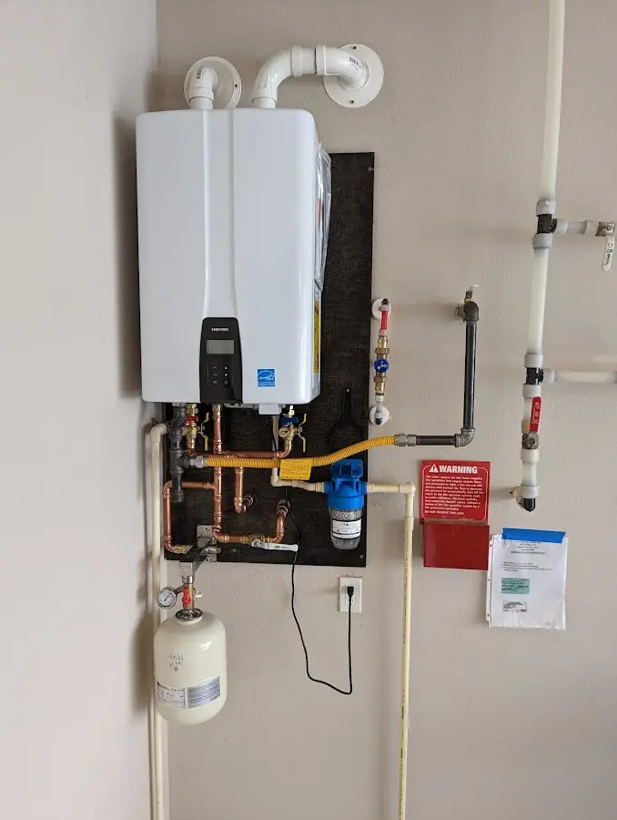 Professional plumber installing copper piping in a Wilmington home